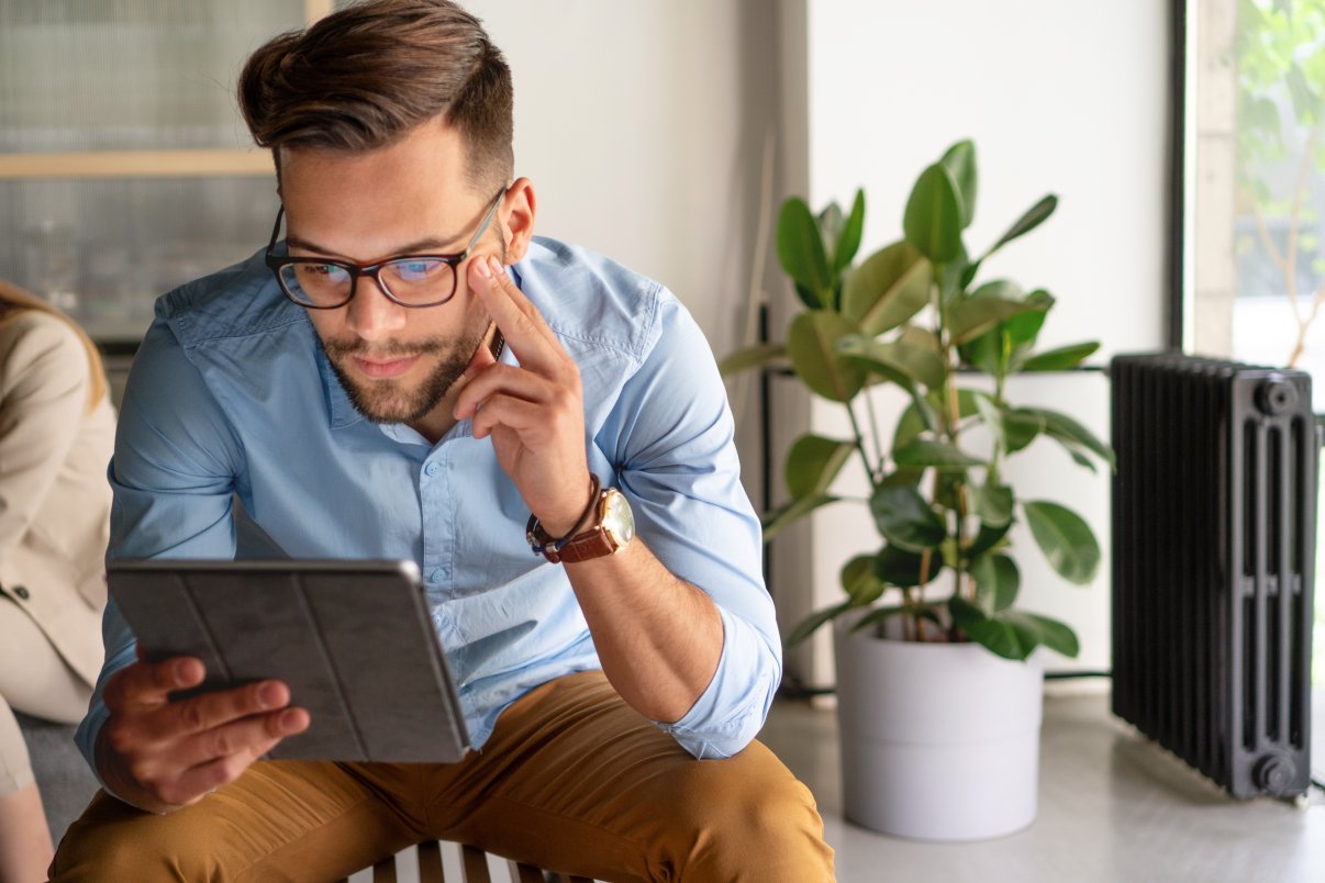 Male reading terms and conditions on tablet 