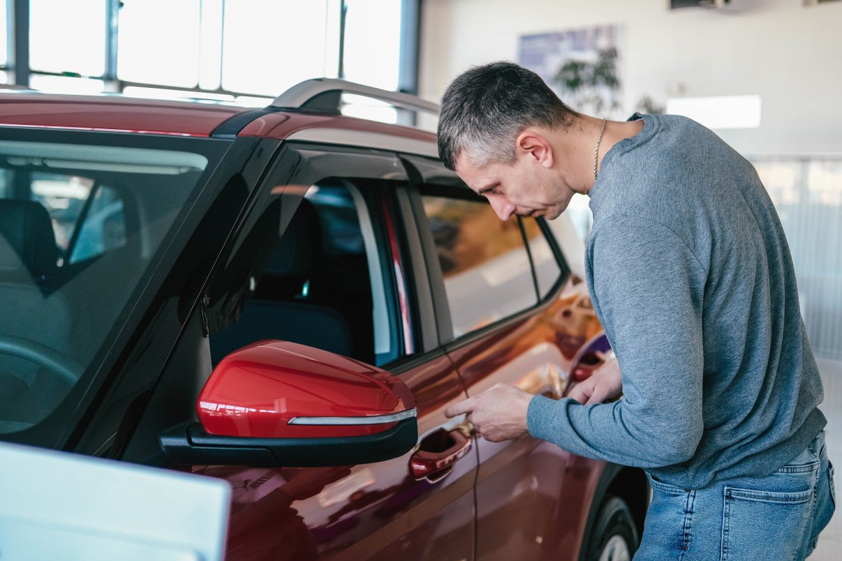 Man inspecting a rental car