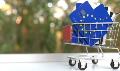 Bank cards with EU flag on it in a shopping cart