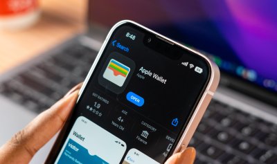 laptop and mobile phone displaying apple wallet 