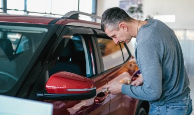Man inspecting a rental car