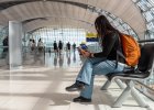 Woman waiting at airport checking flight info